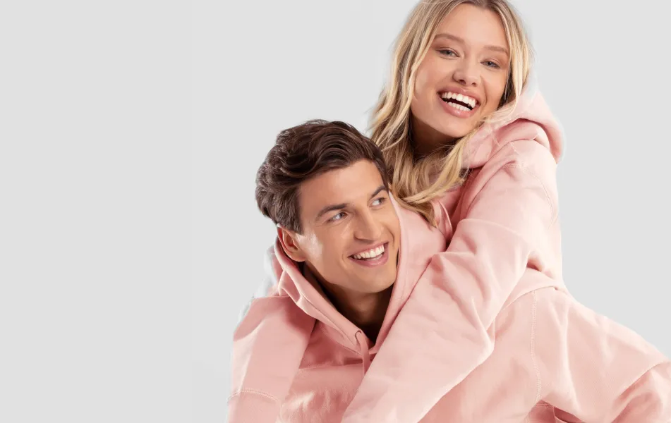 Two models modeling plain hoodies